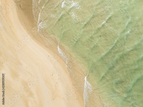 Captured from a drone directly overhead, the meeting of the turquoise sea and white sand makes for a stunning backdrop
