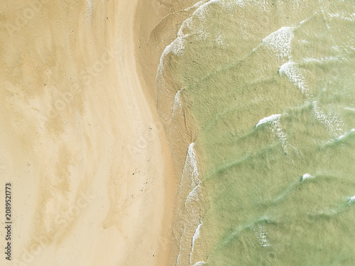 Captured from a drone directly overhead, the meeting of the turquoise sea and white sand makes for a stunning backdrop