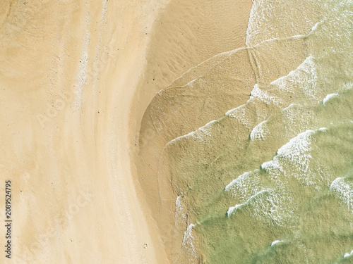 Captured from a drone directly overhead, the meeting of the turquoise sea and white sand makes for a stunning backdrop