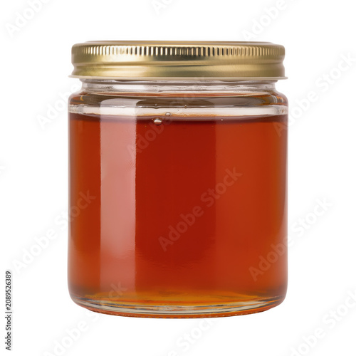 Glass jar filled with amber honey during bright studio lighting isolated on transparent background