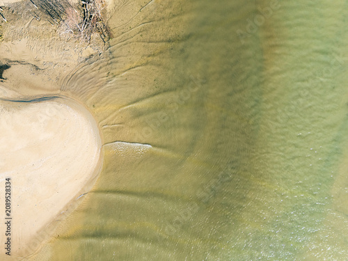 Captured from a drone directly overhead, the meeting of the turquoise sea and white sand makes for a stunning backdrop