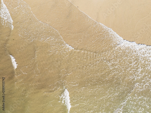 Captured from a drone directly overhead, the meeting of the turquoise sea and white sand makes for a stunning backdrop