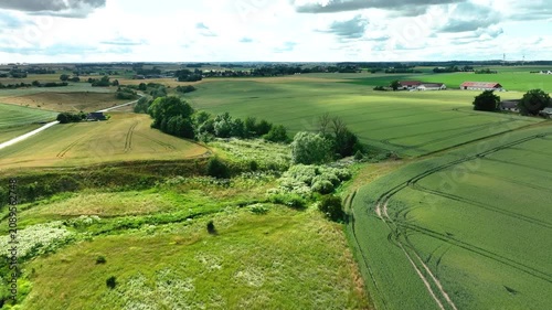 Aerial flight over a green european countryside