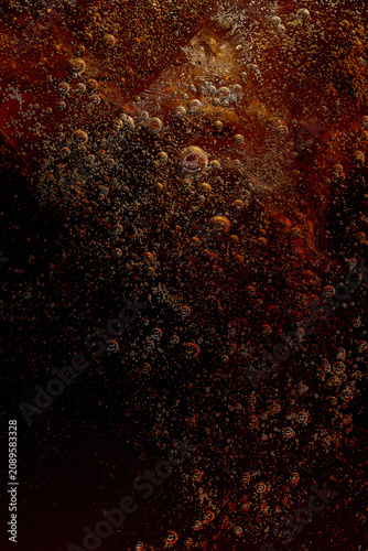 Photography Dark carbonated soft drink with ice cubes and bubbles