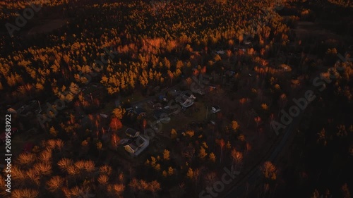 Aerial view of a village during a beautiful orange sunset