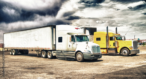Colourful big trucks parked in the countryside
