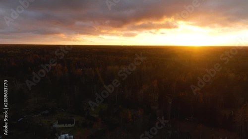 Aerial flight over autumn forest at sunset