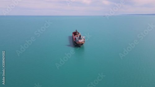 Aerial View of Cargo Ship Anchored in Calm Turquoise Sea