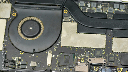 Fotografie Dirty laptop cooling fans with dust buildup inside computer internal hardware