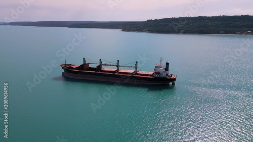 Aerial View of Large Cargo Ship Anchored Near the Coastline