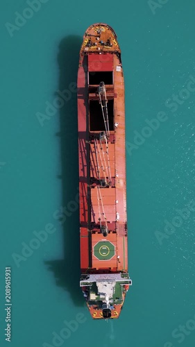 Top Down Aerial View of Cargo Ship in Turquoise Sea
