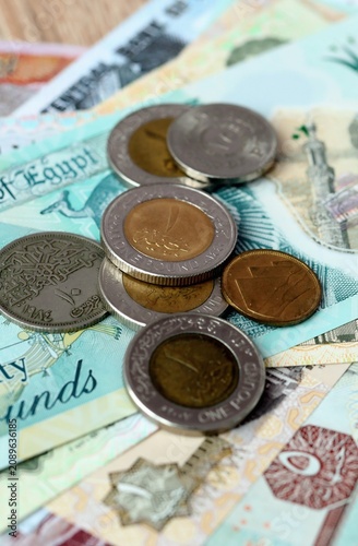 Egyptian pound money bills and coins on table. Egypt cash of EGP currency close up