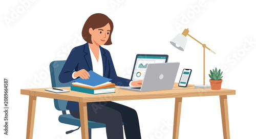 A professional woman in a suit sits at a wooden desk, multitasking with two laptops and organizing a stack of colorful folders.