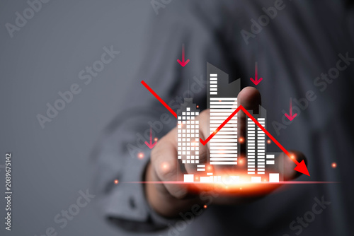 Economic downturn concept with declining real estate market, financial crisis graph, property investment loss, business recession analysis and urban economy risk displayed on virtual interface.