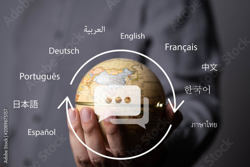 Hand holding a globe with multilingual communication, representing global communication, language translation, international business, cultural diversity, worldwide connection, localization.