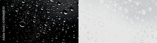 Raindrops on a transparent surface showing moisture and clear outlines of droplets on a smooth background