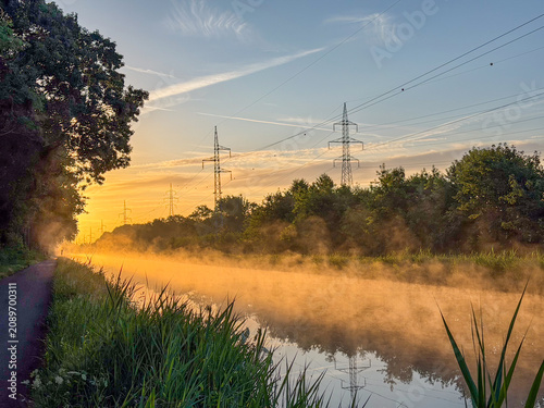 Misty Golden Sunrise over Canal with Power Pylons – Brecht, België