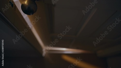 Low Angle View of Interior Door Closing Into Darkness After Brief Opening, Suspense, Mystery, Fear, Horror Atmosphere, Cinematic Thriller