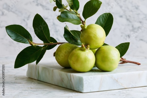 Fresh Green Fruits on Marble Surface with Green Leaves Showcasing Gourmet Ingredients