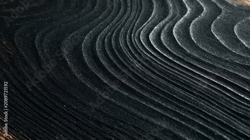 Shou sugi ban charred wood texture with smoky black waves