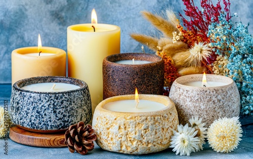 Elegant Soy Candles in Natural Containers Surrounded by Dried Flowers and Warm Accents