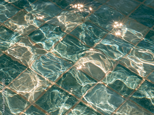 Turquoise pool water with mosaic pattern and bright highlights