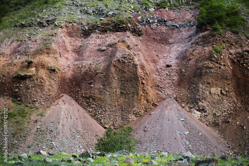 Red eroded volcanic hillside with loose scree deposits