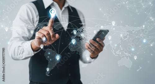 Businessman using mobile phone with digital map and location markers for global business networking