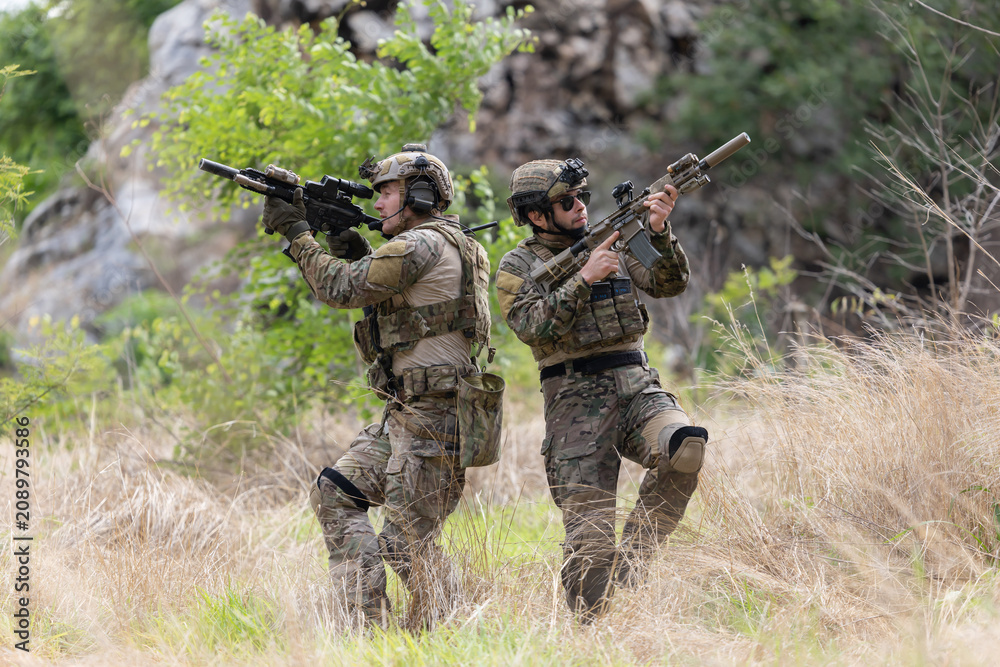 Fototapeta premium Military participate in a patrol in a rocky terrain