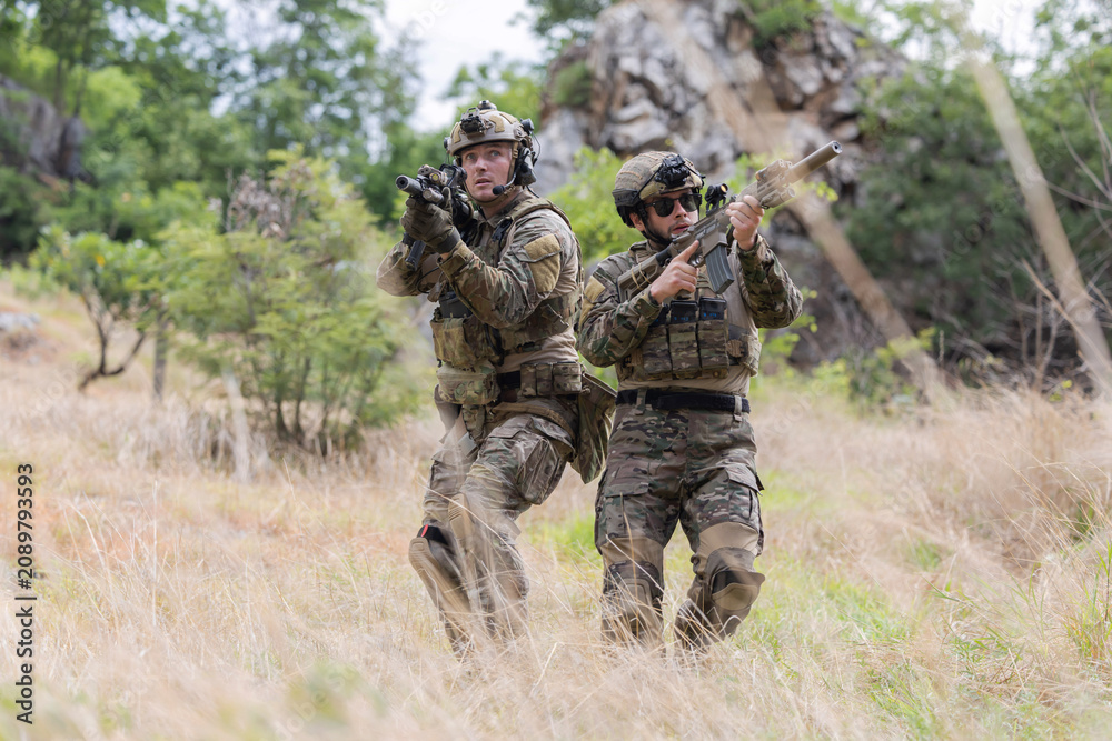 Fototapeta premium Military participate in a patrol in a rocky terrain