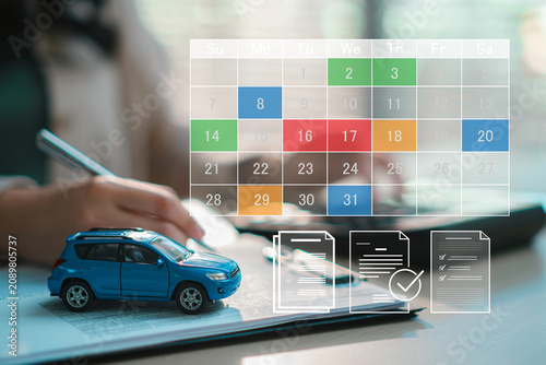 Toy car model on financial document with virtual calendar for auto loan payment schedule