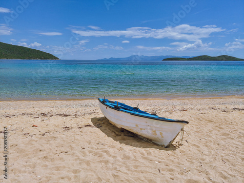 Fishing boat on the beach of Nea Peramos with fine sand and turquoise blue waters, Nea Peramos, Macedonia, Greece