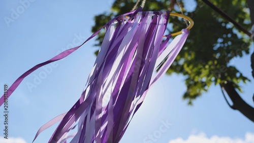 Photography Purple ribbons fluttering in wind at India Day event in Moscow park under blue s
