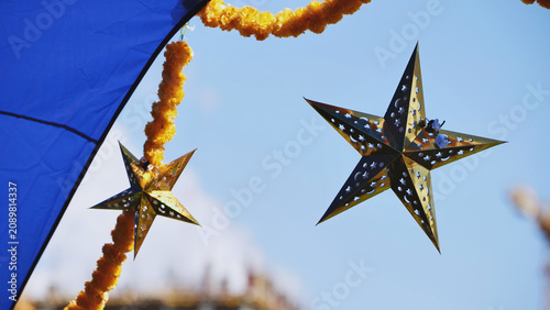 Photography India Day Moscow festival decorations with golden stars and marigold garlands ag