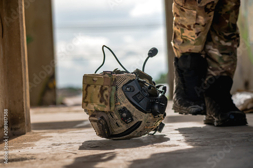 Bild auf Leinwand Close up shot of a combat military helmet placed upside down on the ground, symb
