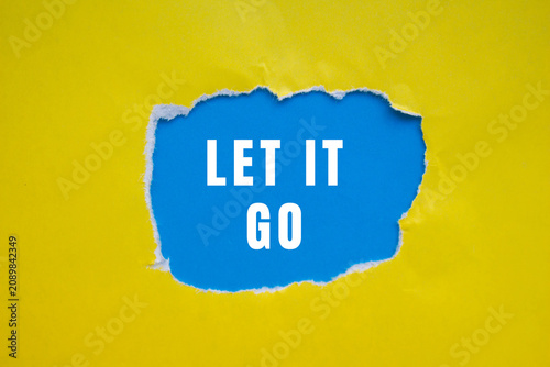 Billede på lærred Torn yellow paper creating a hole, revealing a blue background with the white te