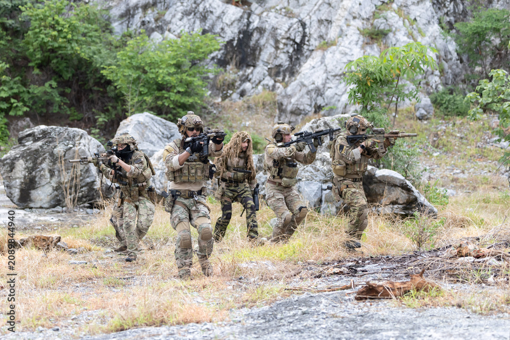 Fototapeta premium Military participate in a patrol in forest terrain