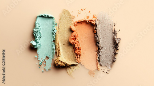 Eyeshadow pigment swatches arranged in a row, showing a variety of colors and textures for makeup and beauty themes