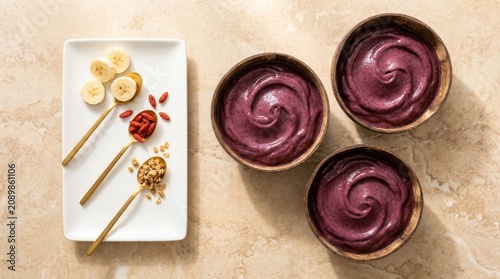 Tasty acai bowls adorned with vibrant fresh fruits and nutritious toppings on a bright background