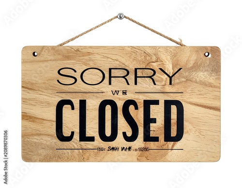 Wooden sorry we are closed sign hanging on door.