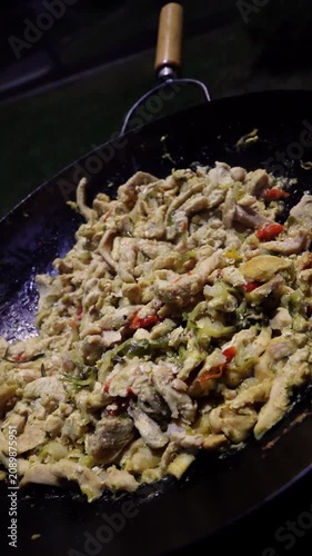 Close Up of Chicken Fajitas Cooking in a Cast Iron Pot at an Outdoor Fiesta Celebration