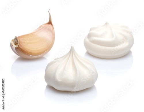 A close-up of meringue cookies and a halved bulb
