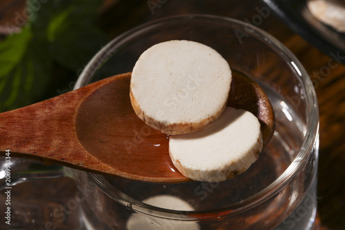 Traditional Chinese Dried Yam Slices on Wooden Spoon - Natural Root Vegetable Ingredient for Herbal Medicine and Cooking