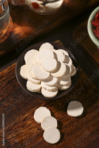 Fresh White Yam Slices in Bowl on Wooden Table - Healthy Root Vegetable Food Photography
