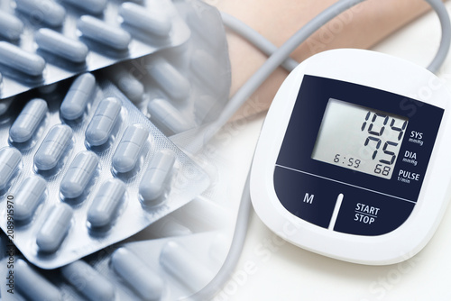 Foto Digital blood pressure monitor combined with blister packs of tablets