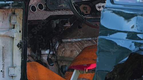 Close up view of muddy off road vehicle interior. Custom diamond plate dashboard and steering wheel show wear from extreme racing. Gritty, powerful concept for motorsports and adventure