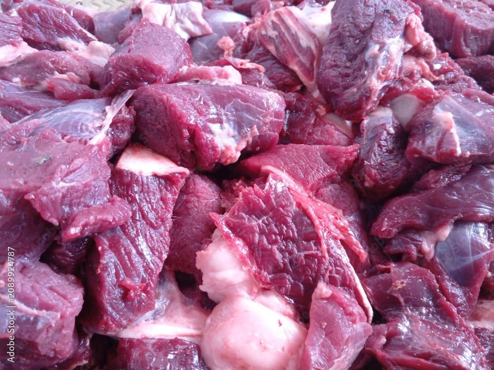 Obraz premium Raw cut red meat chunks piled together