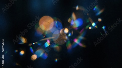Bokeh lights on dark background with colorful lens flares