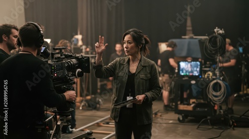 Asian female director giving instructions on a film set