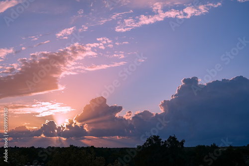 Bilde på lerret Clouds adorn the summer evening sky